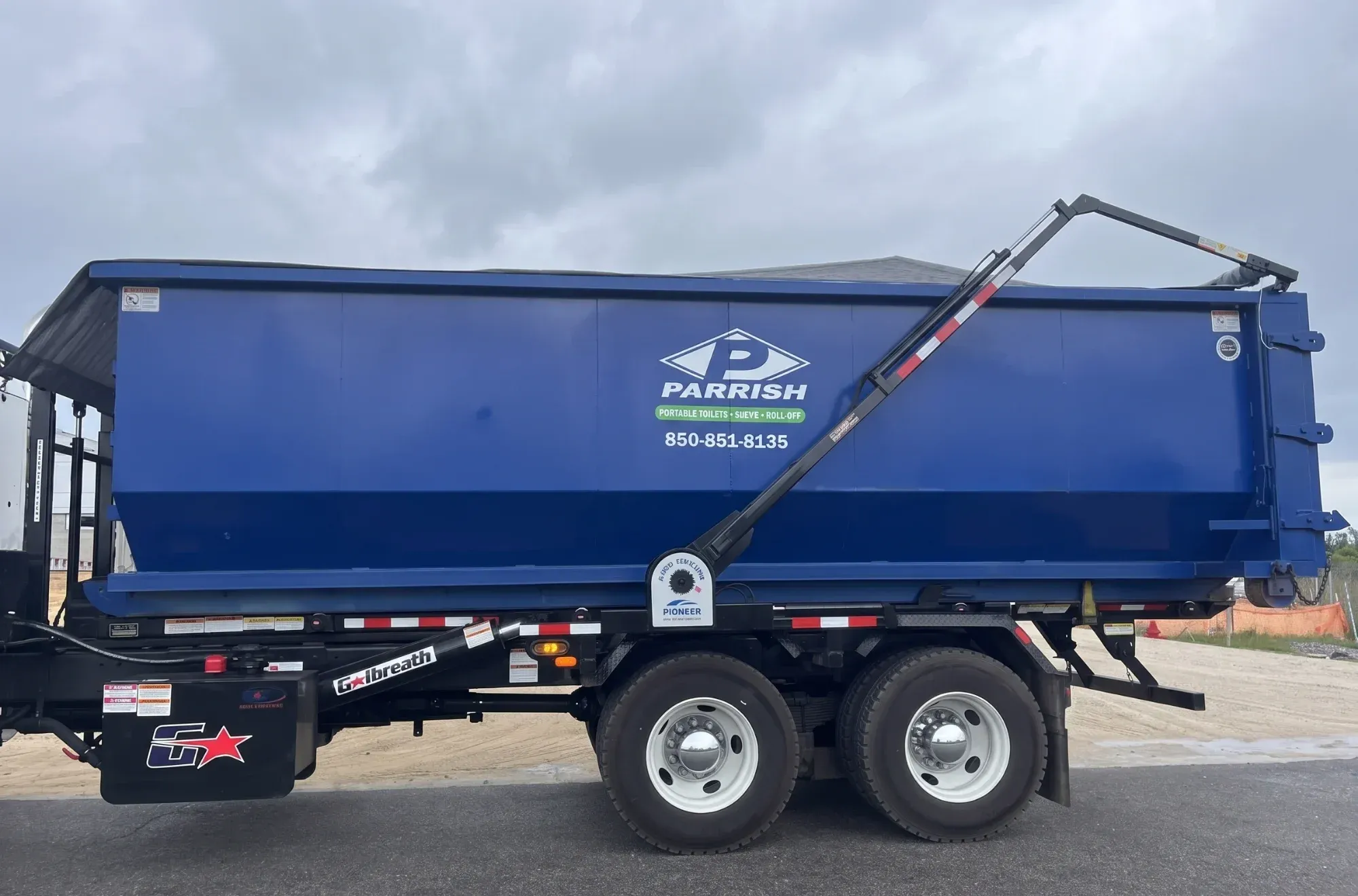 Parrish roll off dumpster loaded on a roll off truck